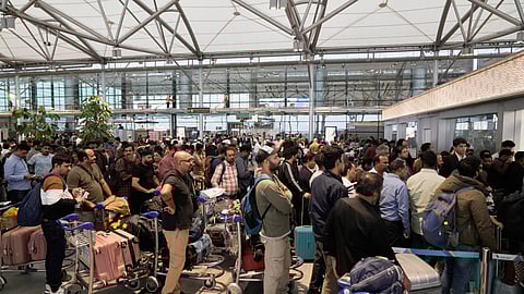 Passengers line up at an IndiGo Airlines ticket counter at the Rajiv Gandhi International Airport in Hyderabad, India, as several Indigo Airlines flights were either cancelled or delayed, Friday, Dec. 5, 2025.