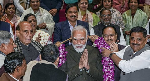 Prime Minister Narendra Modi being felicitated by MPs for the alliance victory in Bihar Assembly elections during the NDA Parliamentary Party meeting, at Parliament premises in New Delhi, Tuesday, Dec. 9, 2025.