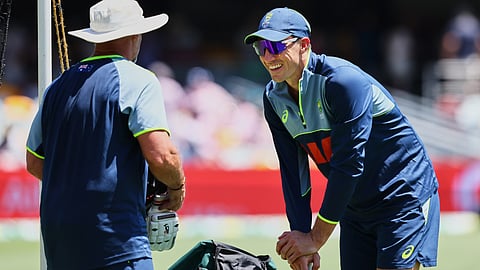 Australia's Pat Cummins, right, warms up before start of the second Ashes cricket test match between Australia and England in Brisbane, Thursday, Dec. 4, 2025.