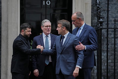 Ukrainian President Volodymyr Zelenskyy, left, with Britain's PM Keir Starmer, French President Emmanuel Macron, and German Chancellor Friedrich Merz pose on the doorstep of 10 Downing Street, London, Monday, Dec. 8, 2025, following a meeting of the leaders inside.
