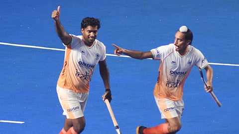Sharda Nand Tiwari (L) celebrates a goal during the FIH Hockey Men's Junior World Cup