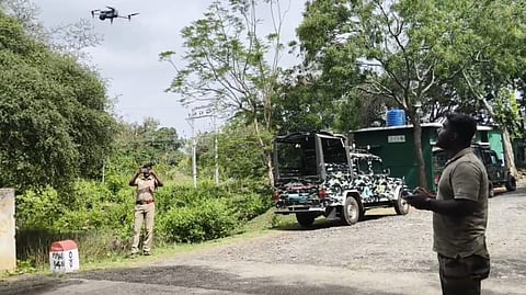 Forest department staff fly a drone to monitor the tiger in the Singara forest range | Express