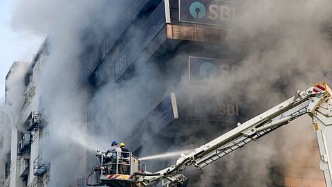 Firefighters try to douse a fire that broke out at Swagota Square, Sohum Emporia, in Guwahati, Wednesday, Dec. 10, 2025.
