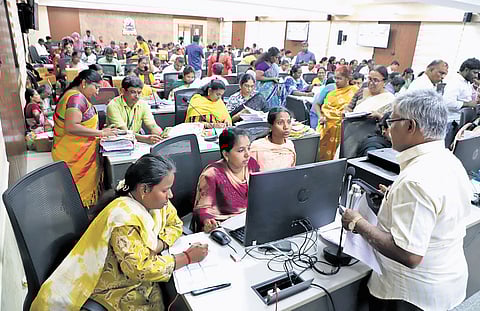 BLOs sorting and uploading hundreds of applications at RS Puram Kalaiarangam in Coimbatore on Thursday
