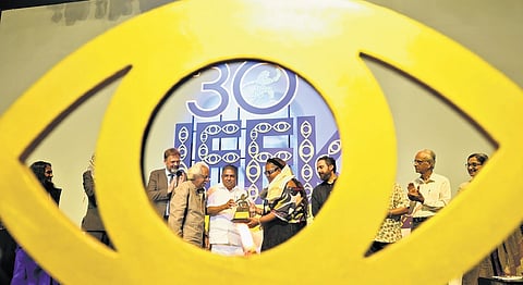 Cultural Affairs Minister Saji Cherian presents the Spirit of Cinema Award to Canadian filmmaker Kelly Fyffe-Marshall at the inaugural ceremony of IFFK at Nishagandhi auditorium in Thiruvananthapuram on Friday