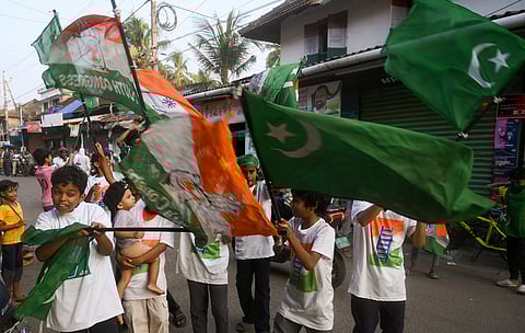 Children waving flags during the UDF victory celebration in Mugadar in kozhikode.