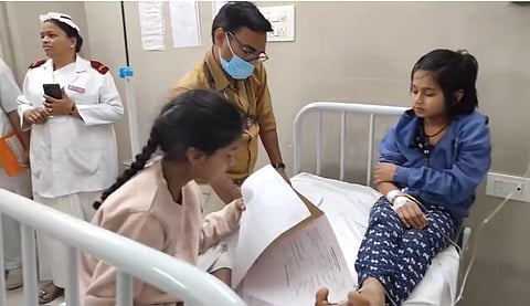 A doctor checks one of the 16 students from a minority school in Baghlingampally that fell ill due to suspected food poisoning on Friday