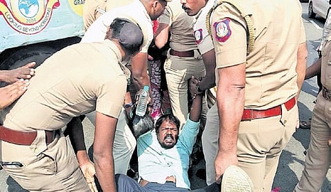 Sanitary workers from Royapuram and Thiru-Vi-ka Nagar zones staging protest near the memorial.