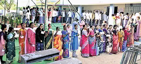 People stand in long queues to cast their votes during the second phase of panchayat elections in Karimnagar.