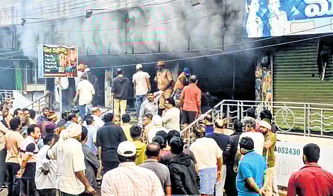 According to fire department officials, the blaze may have started at a mobile phone shop, though the exact cause is yet to be determined.