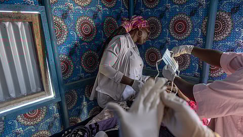 A young Malian woman is treated for her dangerously high fever and infection by doctors at the Douankaran health clinic in the Hodh El Chargui Region, Mauritania, Nov. 7, 2025.