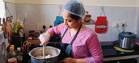 S Saranyabai stirs a pot in her home kitchen in Thiruverumbur, part of the growing wave of cloud kitchens in Tiruchy