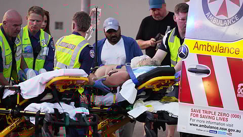 Emergency workers transport a person on a stretcher after a reported shooting at Bondi Beach in Sydney, Sunday, Dec. 14, 2025.