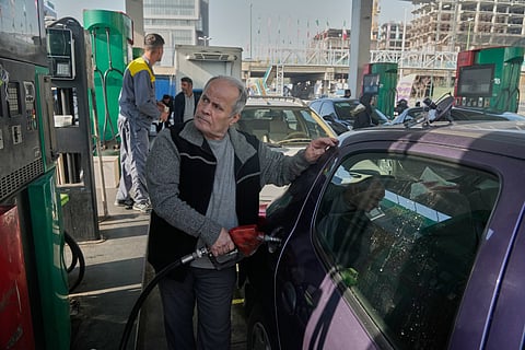 A man fills his car at a gas station in Tehran, Iran, Saturday, Dec. 13, 2025.