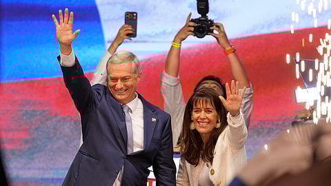 Presidential candidate Jose Antonio Kast, of the opposition Republican Party, and his wife Maria Pia Adriasola wave to supporters after winning the presidential runoff election in Santiago, Chile, Sunday, Dec. 14, 2025.