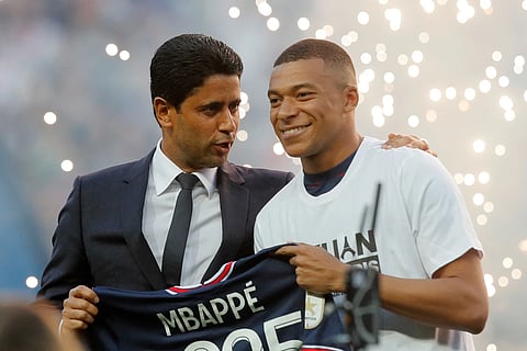 PSG President Nasser Al-Khelaifi, left, speaks to PSG's Kylian Mbappé as it announced he has signed a three year extension to his contract, at the Parc des Princes stadium in Paris, France, Saturday, May 21, 2022.