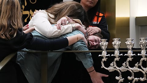 Family react at the coffin of Rabbi Eli Schlanger, a victim in the Bondi Beach mass shooting, during his funeral at a synagogue in Bondi on Wednesday, Dec. 17, 2025, in Sydney, Australia.