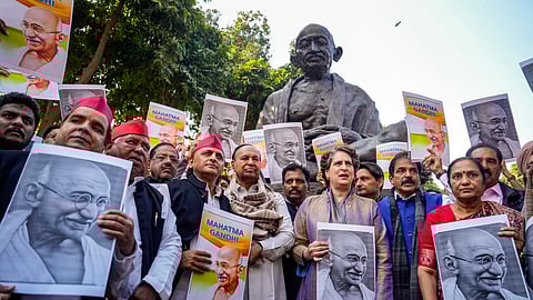 Congress MP Priyanka Gandhi Vadra, Samajwadi Party MP Akhilesh Yadav, DMK MP T.R. Baalu and other opposition MPs stage a protest near the statue of Mahatma Gandhi against the VB-G RAM G Bill, introduced by the union government to replace the Mahatma Gandhi National Rural Employment Guarantee Act (MGNREGA), 2005, during the Winter Session of Parliament, in New Delhi, Tuesday, Dec. 16, 2025.