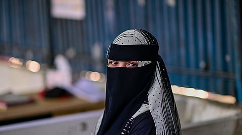 Hasina, a Rohingya refugee girl, sits inside the Rohingya refugee camp in Cox's Bazar, Bangladesh, Thursday, Nov. 20, 2025.