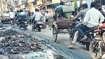 Silt generated from drain cleaning work lying on the roadside, on Haripur-Dolamundai road