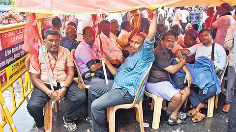 Tasmac employees staging a wait-in protest in Chennai on Tuesday