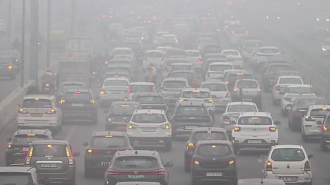 Vehicles ply on NH-24 on a foggy winter morning, near Akshardham Temple, in New Delhi, Thursday, Dec. 18, 2025.