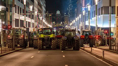 Farmers drive their tractors to block a main boulevard during a demonstration outside a gathering of European leaders at the EU Summit in Brussels, Thursday, Dec. 18, 2025.