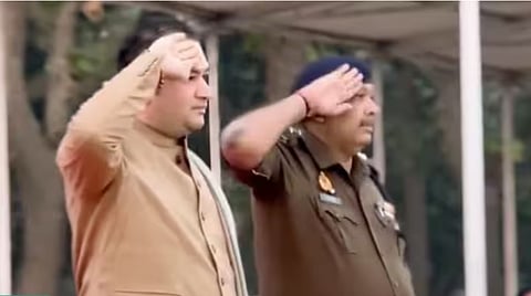 Screengrab of a video showing religious preacher Acharya Pundreek Goswami allegedly accepting a salute from the recruits with the SP standing beside him.