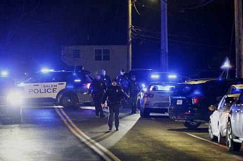 Law enforcement officers search the area for the Brown University shooting suspect, Thursday, Dec. 18, 2025, in Salem, N.H