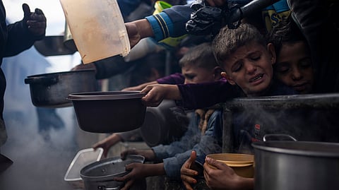 Palestinian children line up for a free meal in Rafah, Gaza Strip.