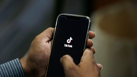 FILE - In this July 21, 2020 file photo, a man opens social media app 'TikTok' on his cell phone, in Islamabad, Pakistan