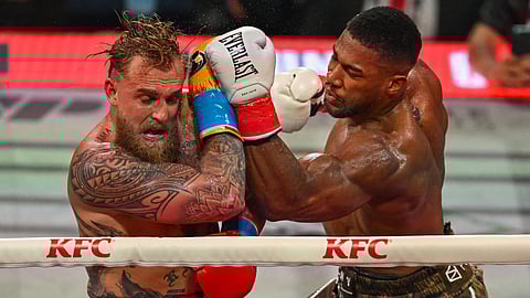 US boxer and influencer Jake Paul (L) and British boxer Anthony Joshua fight in a non-title heavyweight bout at the Kaseya Center in Miami, Florida on December 19, 2025.