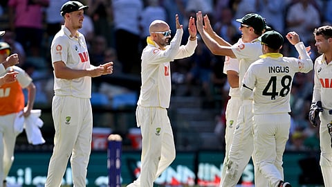 Australian spinner Nathan Lyon (C) celebrates dismissing England batsman Harry Brook on the fourth day of the third Ashes cricket Test match at the Adelaide Oval in Adelaide on December 20, 2025.