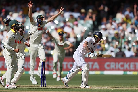 Australian players celebrate after England's Ben Stokes, right, was dismissed during play on day four of the third Ashes cricket test between England and Australia in Adelaide.