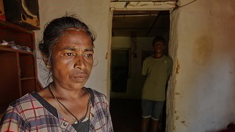 Arumugam Manikavalli stands at the doorway to her living quarters after Cyclone Ditwah led to floods and landslides at Craighead Estate in Nawalapitiya, Sri Lanka, Friday, Dec. 12, 2025.