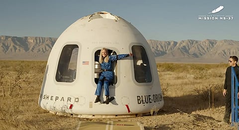 This image provided by Blue Origin, Michaela Benthaus poses after the Blue Origin's capsule landed on Saturday, Dec. 20, 2025 in West Texas.