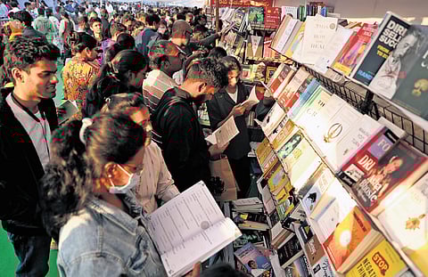 People scan through books at a stall in the Hyderabad Book Fair on Sunday.