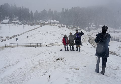 Tourists visit a snow-covered valley amid snowfall during 'Chillai Kalan', in Gulmarg, Jammu and Kashmir.