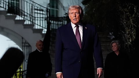 President Donald Trump walks to speak with reporters while departing the White House as chief of staff Susie Wiles, right, looks on, Friday, Dec. 19, 2025, in Washington