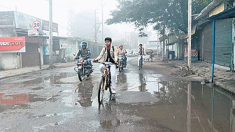 Commuters travelling on the pothole-filled Power House road in Rourkela.