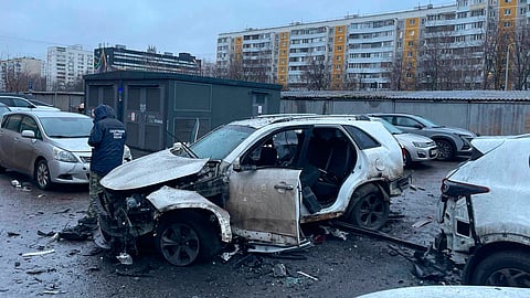 This photo provided by Investigative Committee of Moscow on Monday, Dec. 22, 2025, shows an investigator working at the scene where Lt. Gen. Fanil Sarvarov, head of the Operational Training Directorate of the Russian Armed Forces General Staff, was killed by an explosive device placed under his car in Moscow.