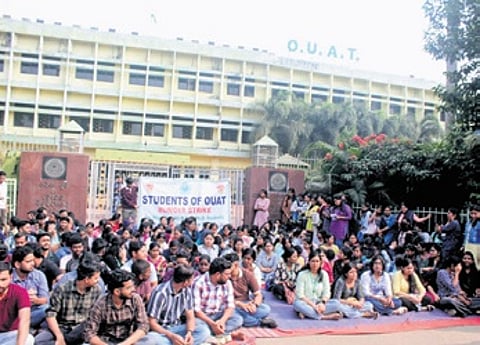 Students protesting in front of OUAT main gate on Monday.
