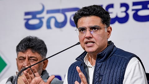 AICC general secretary Sachin Pilot speaks as KPCC president and Karnataka Deputy Chief Minister DK Shivakumar looks on during a press conference at the KPCC office, in Bengaluru, Monday, Dec. 22, 2025.