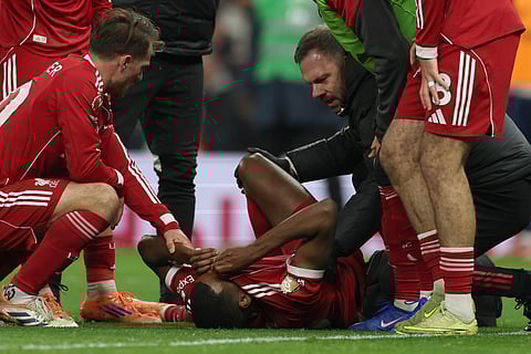 Liverpool's Alexander Isak reacts after sustaining an injury during the English Premier League soccer match between Tottenham and Liverpool in London, Saturday, Dec. 20, 2025.
