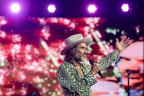 Russell Brand speaks during Turning Point USA’s AmericaFest 2025, Thursday, Dec. 18, 2025, in Phoenix.