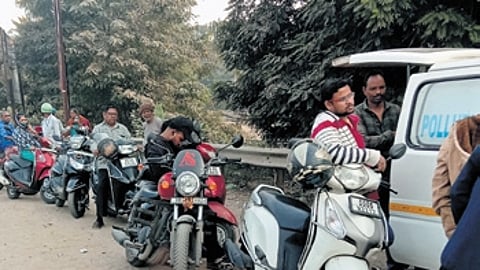 Vehicle owners queue up along the Kathajodi Ring road near CDA to obtain PUCC, in Cuttack
