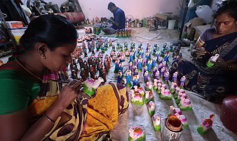 Workers are seen busy making dolls for the Christmas set at Vilacheri near Madurai.
