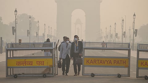 People seen wearing masks as a thick layer of smog engulfs the Kartavya Path area as the Air Quality Index (AQI) remains in the ‘Very Poor’ category in New Delhi.