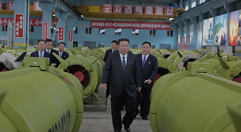 This undated picture released by North Korea's official Korean Central News Agency on December 26, 2025, shows North Korean leader Kim Jong Un (C) visiting major munitions industry enterprises.