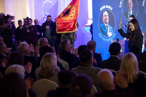 Leader of the PDK (Democratic Party of Kosovo) Bedri Hamza, center, aplauds at political candidates during election rally in the town of Ferizaj on Thursday, Dec. 25, 2025.